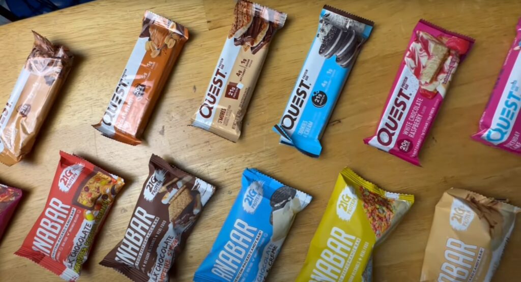 a selection of different Quest Bars on a wooden table