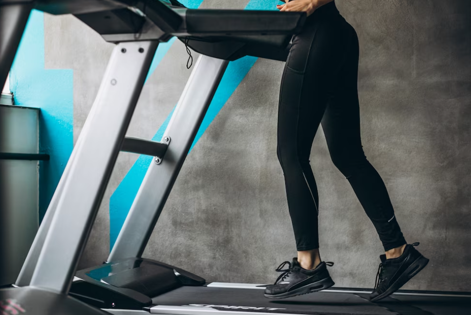 woman in black leggings on a treadmill